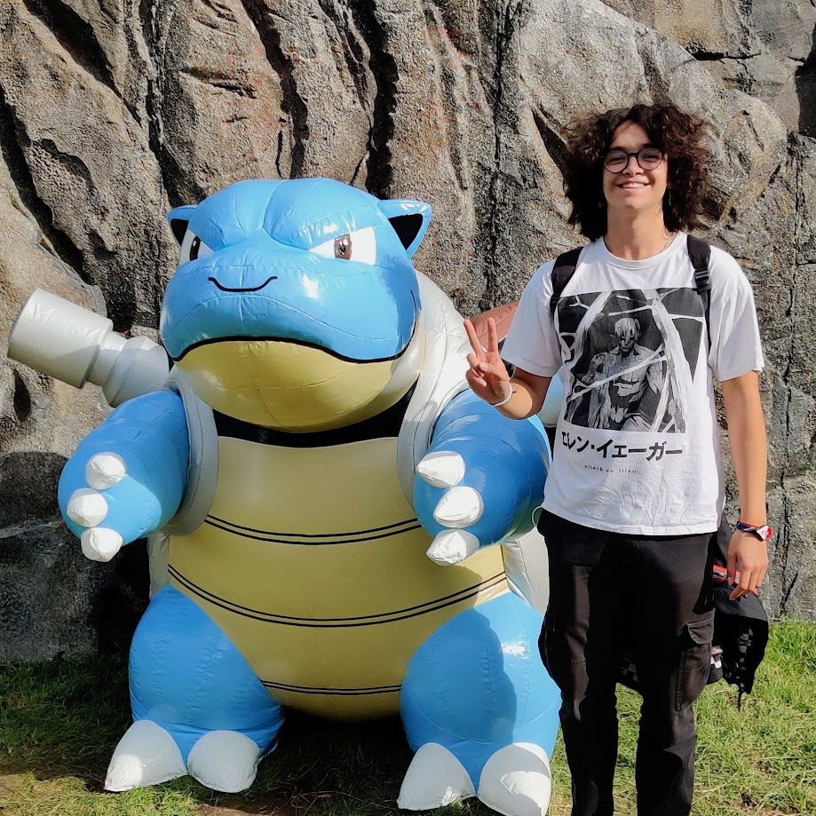 Justin stood next to a big Blastoise blow up at Pokemon Go Fest